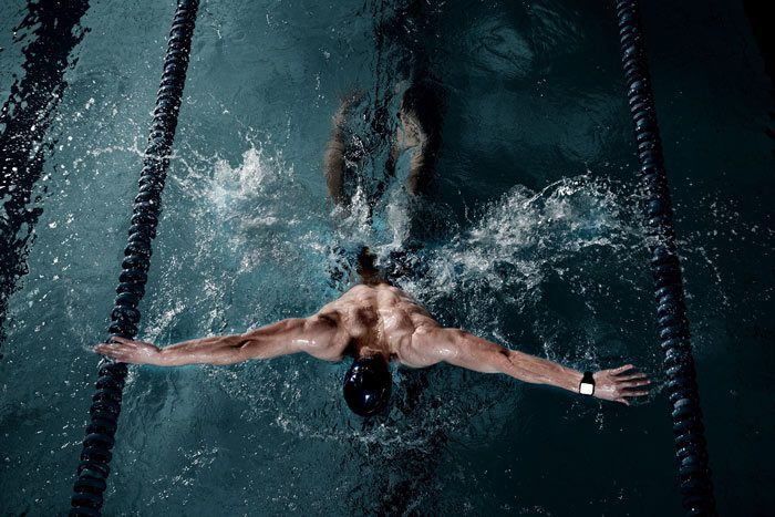 aerial shot of a male swimmer doing the butterfly stroke - athletes