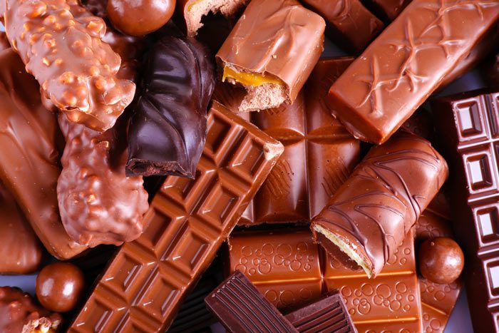 closeup of unwrapped assorted chocolate candy bars - therapy